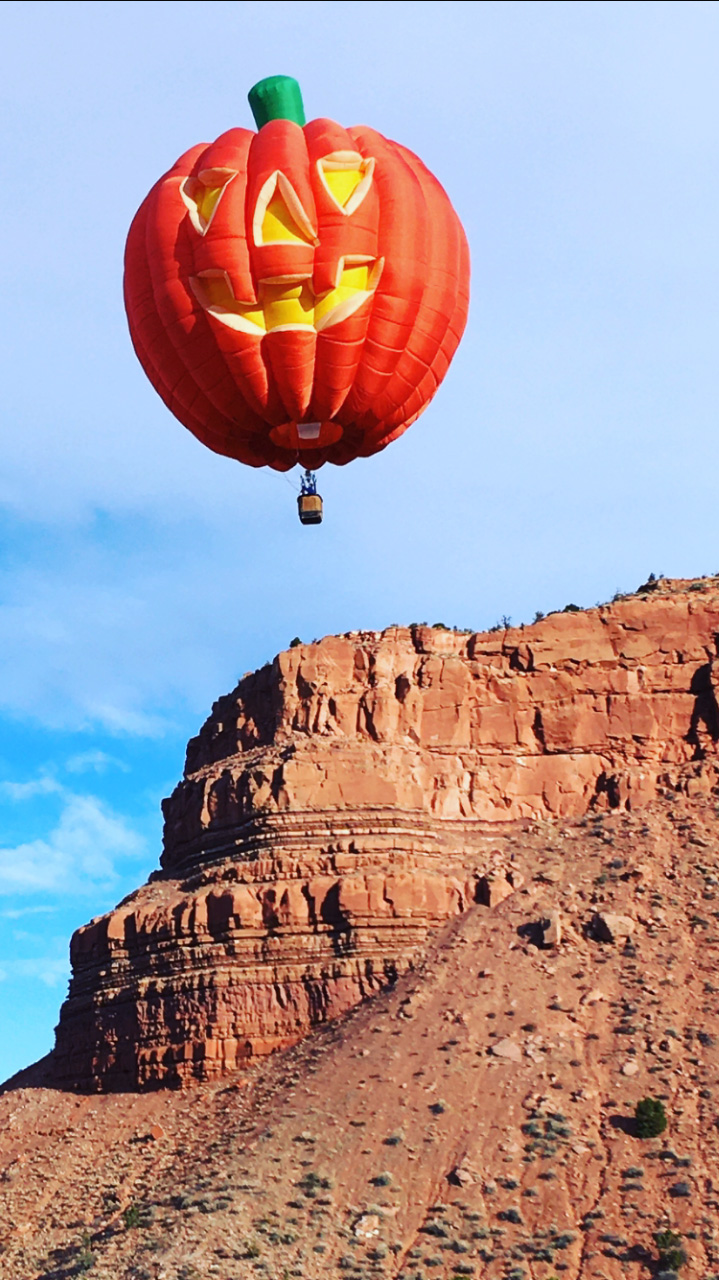 pumpkin shaped hot air ballon ride over cliffs
